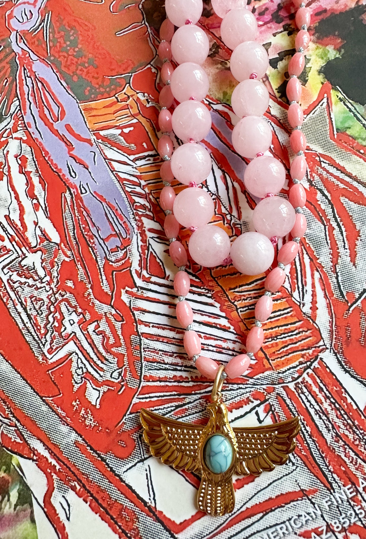 Abilene Necklace featuring pink bamboo beads and a gold thunderbird pendant with a turquoise accent.