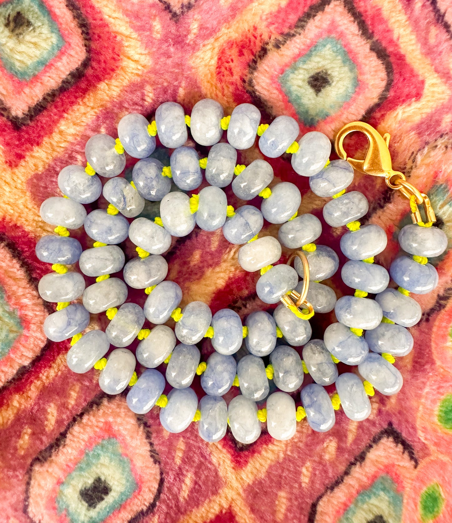 A soft blue beaded necklace with lime green silk knotting. The Hazel Necklace