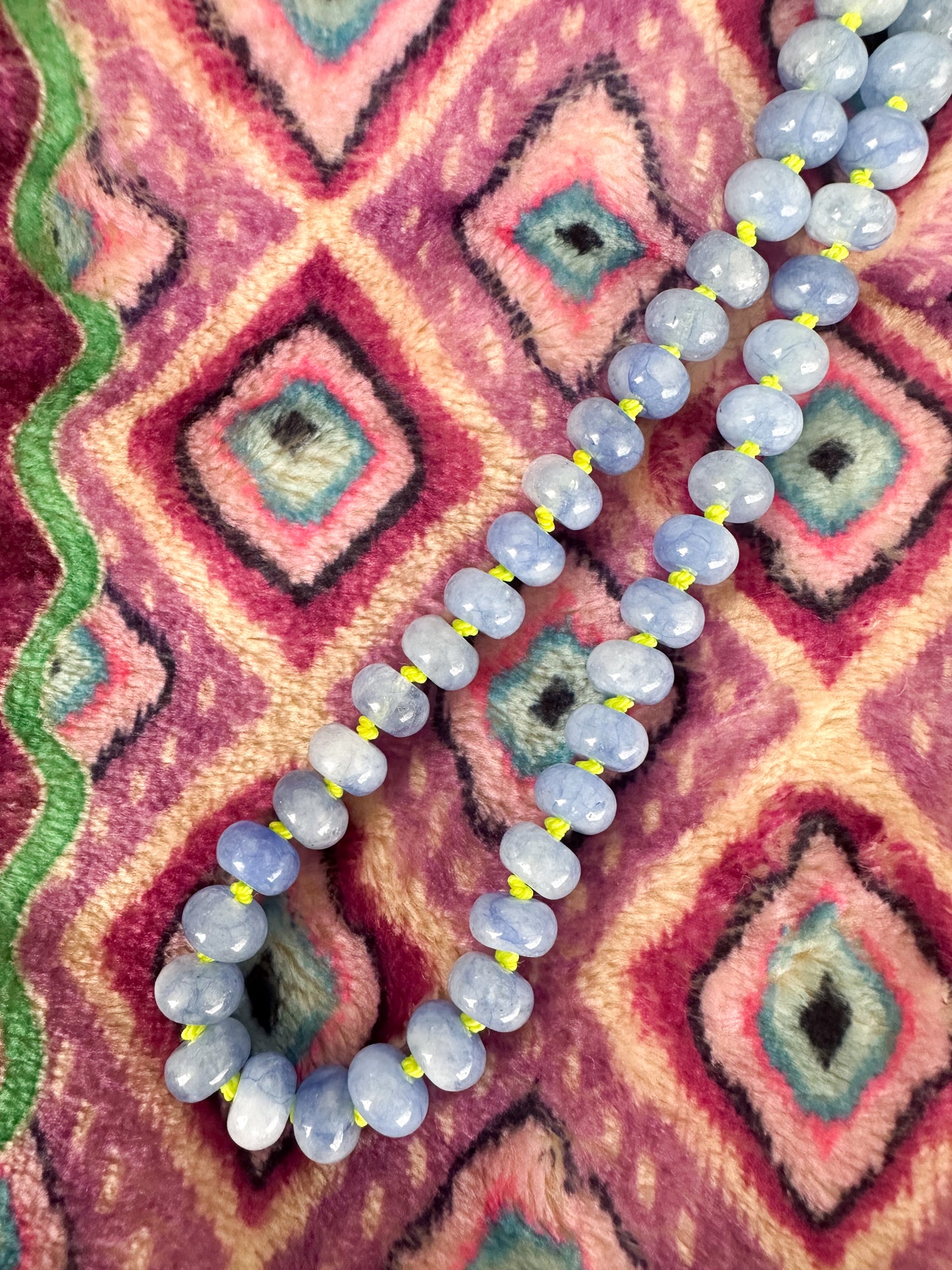 The Hazel Necklace close up of soft blue jade beads and lime green silk knots.