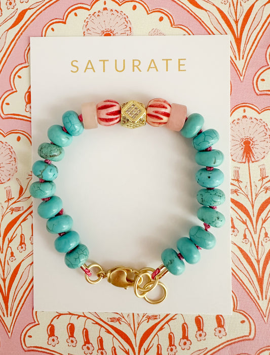 Rowyn bracelet with turquoise beads, pink and gold accent beads, and an adjustable 18K gold plated clasp.